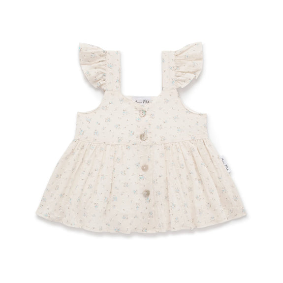 Baby dress with ruffled straps on a white background