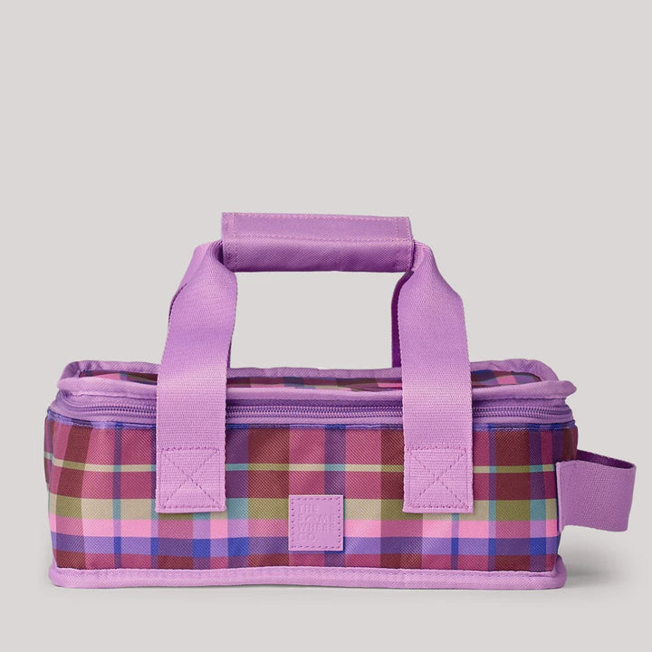 A rectangular insulated lunch bag with a purple handle and zipper, featuring a pink, purple, and blue plaid pattern, set against a light gray background.
