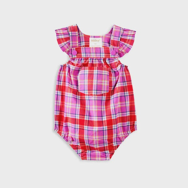 A baby romper with ruffled shoulder straps and a front pocket, featuring a red, pink, and purple plaid pattern, shown flat against a light gray background.