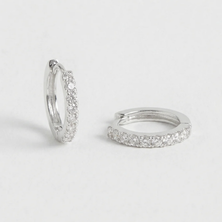 Pair of silver hoop earrings on a light gray background