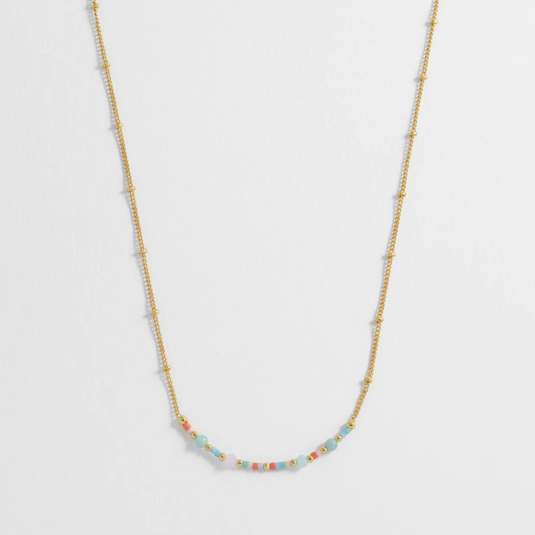 Necklace with small beads on a light gray background