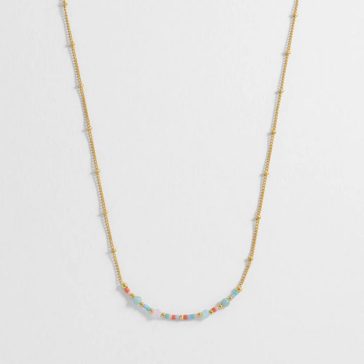Necklace with small beads on a light gray background