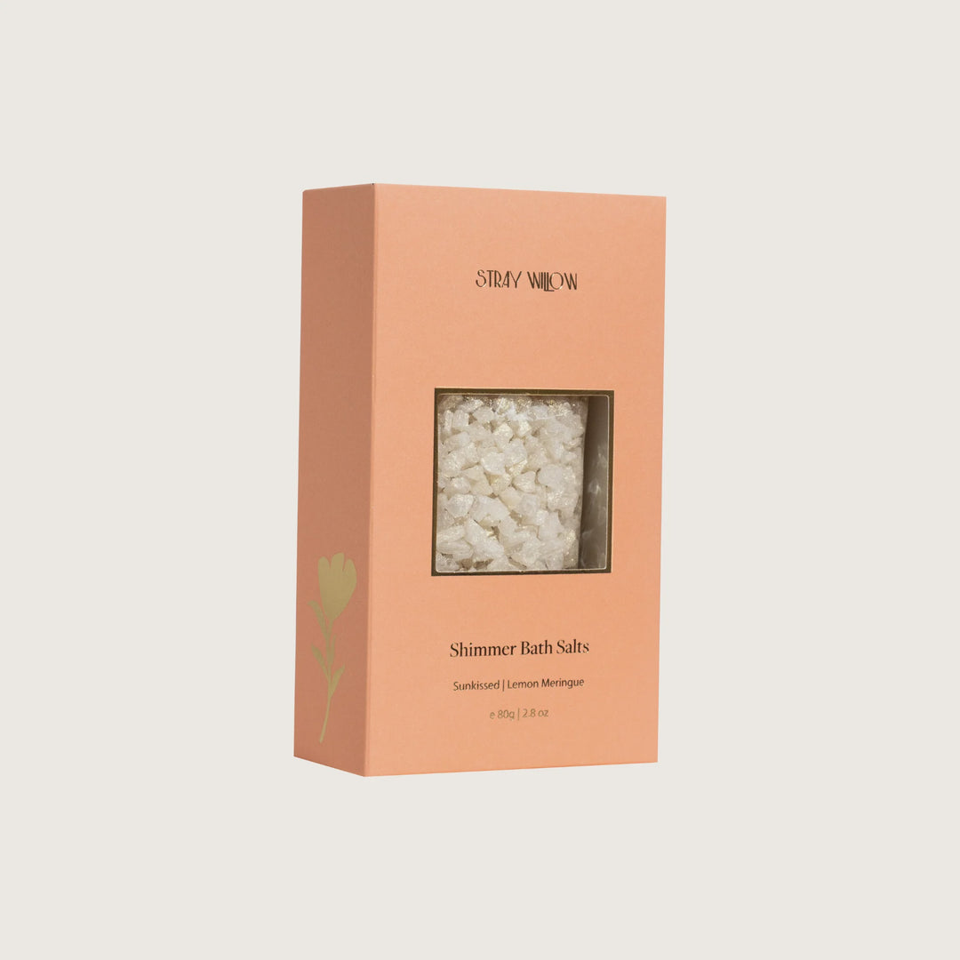 Box of Shimmer Bath Salts with visible contents on a light beige background