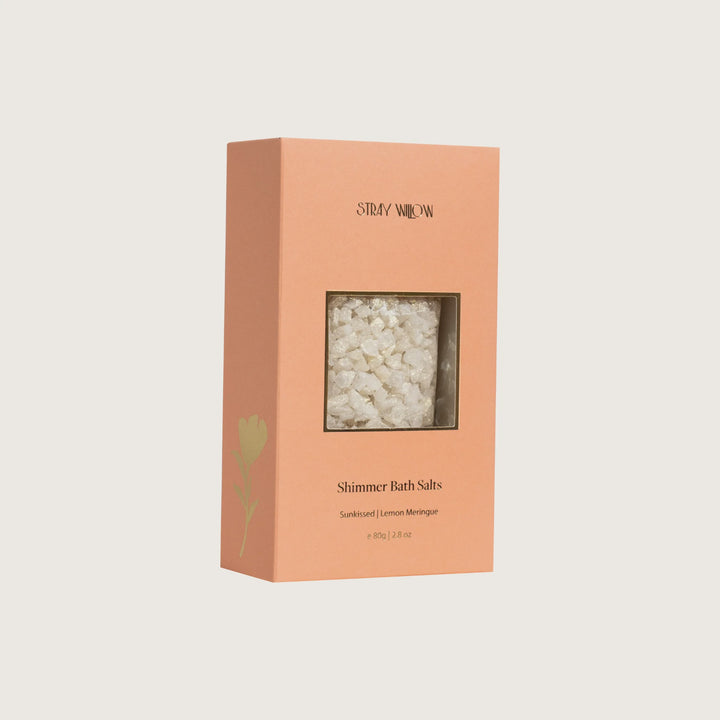 Box of Shimmer Bath Salts with visible contents on a light beige background