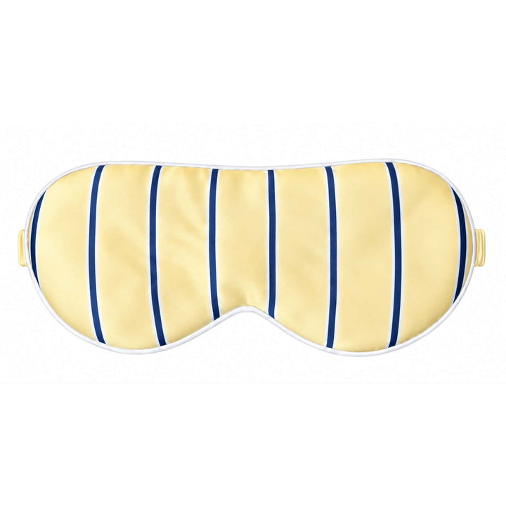 A pale yellow sleep mask with vertical navy blue stripes and a white border, shown against a plain white background.