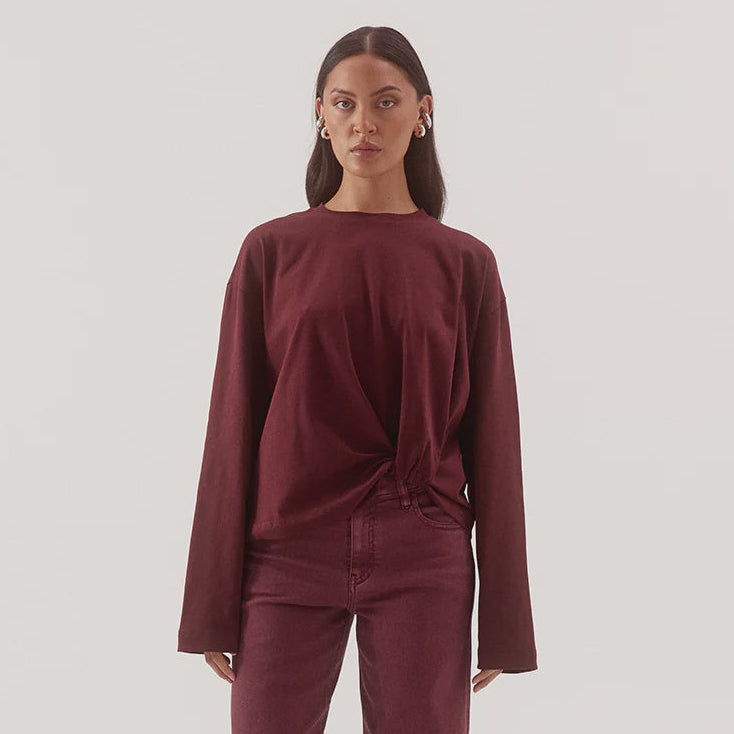 Woman wearing a burgundy outfit on a white background
