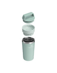 Mint green tumbler with lid on a white background