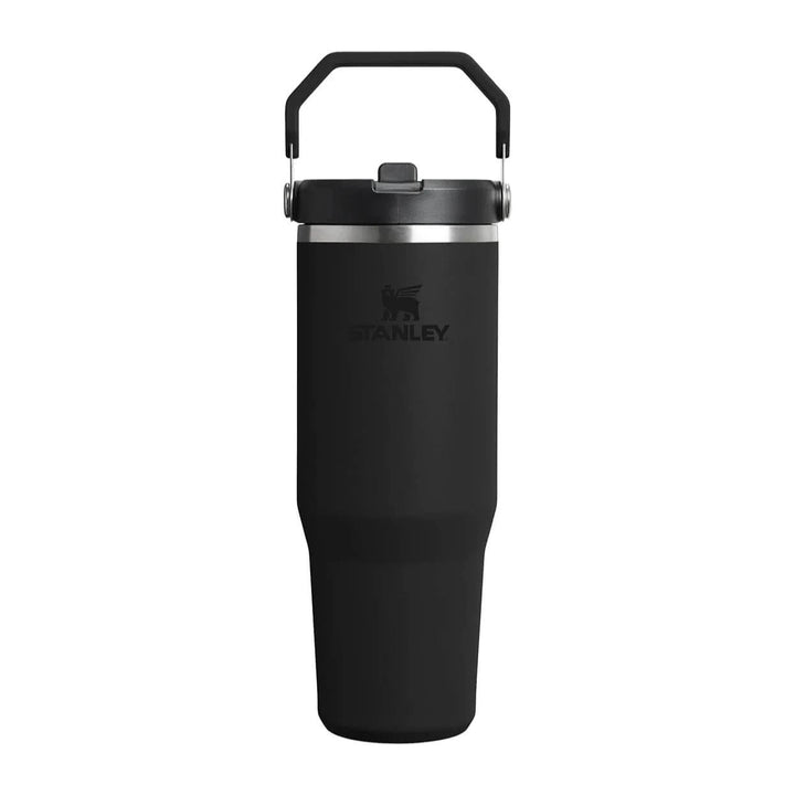 Black Stanley tumbler with handle on a white background