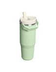 Mint green tumbler with a white lid on a white background