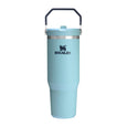 Light blue tumbler with black handle on a white background