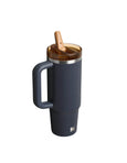 Blue insulated mug with wooden spoon on a white background