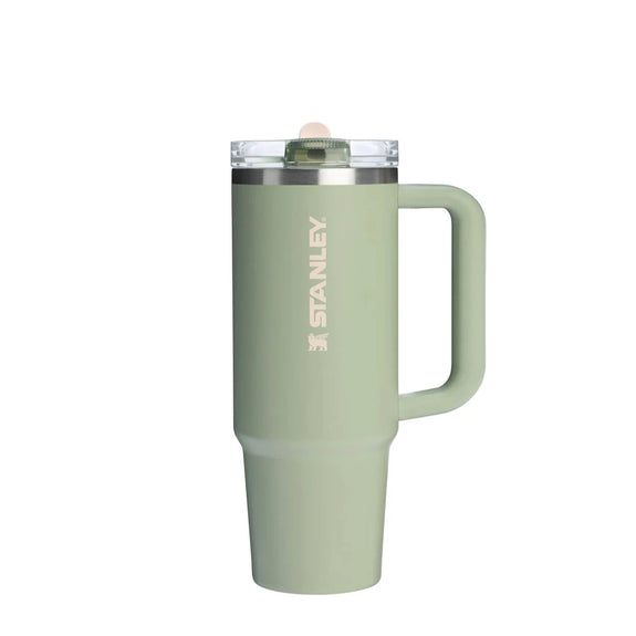 Green Stanley mug with handle on a white background