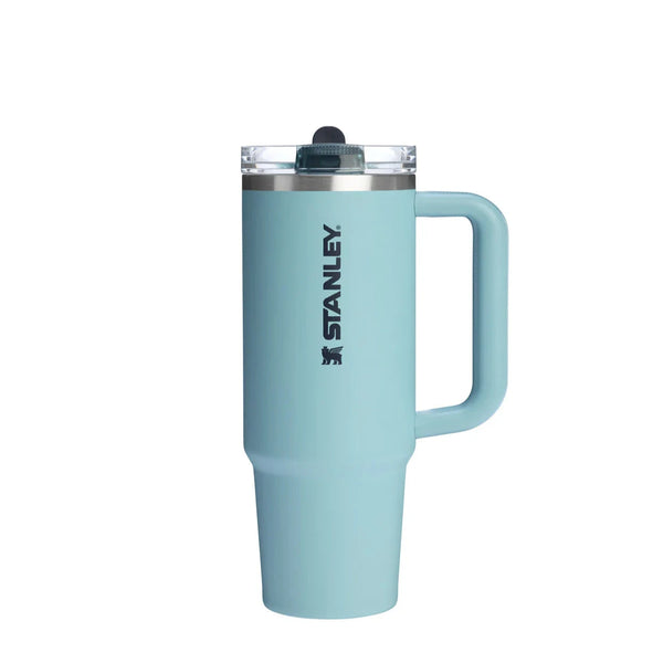 Light blue Stanley tumbler with handle on a white background