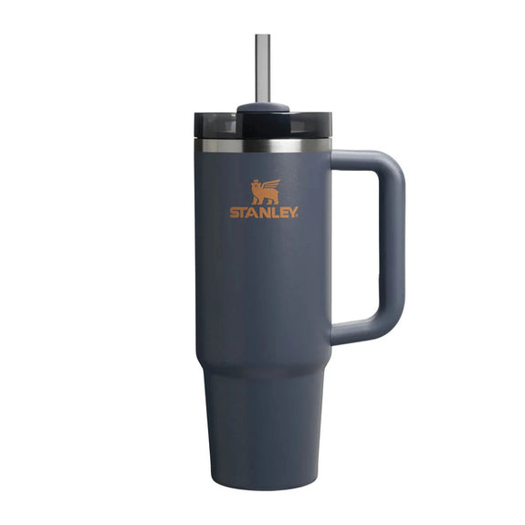 Blue Stanley mug with handle and straw on a white background