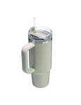 Light green tumbler with a handle and straw on a white background