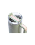 Green insulated mug with pink handle and lid on a white background