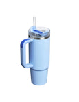 Light blue tumbler with handle and straw on a white background