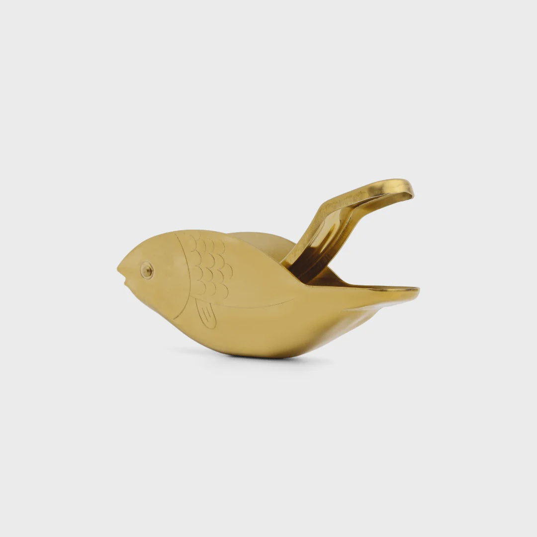 Gold bird-shaped object on a white background
