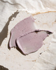 Purple cream smear on a light stone surface