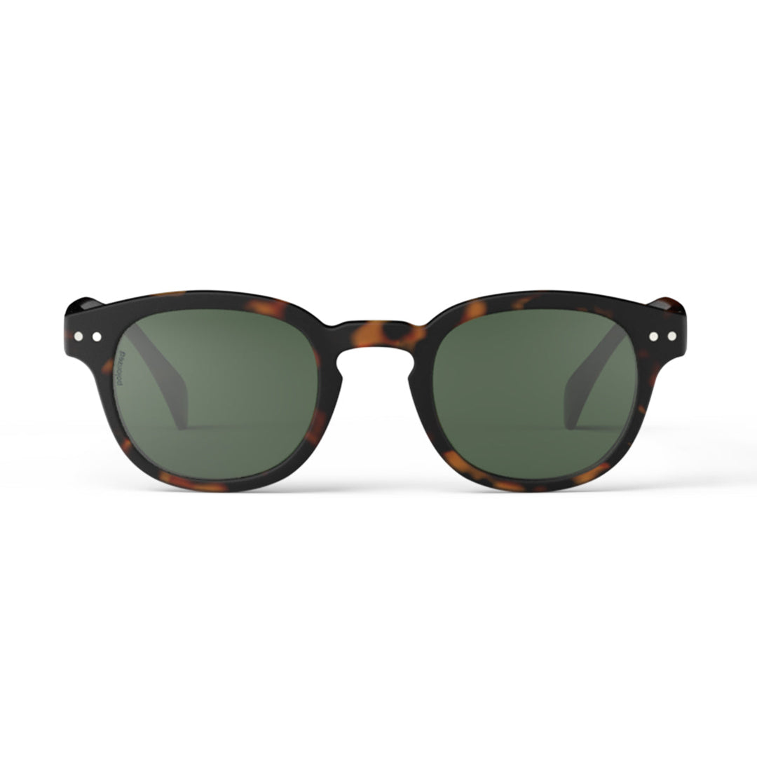 Sunglasses with tortoiseshell frame and dark lenses on a white background