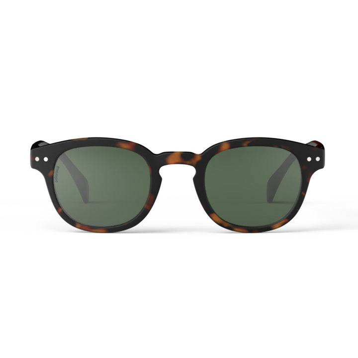 Sunglasses with tortoiseshell frame and dark lenses on a white background