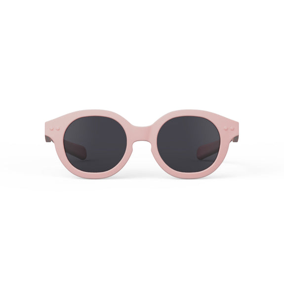 Pink sunglasses with black lenses on a white background
