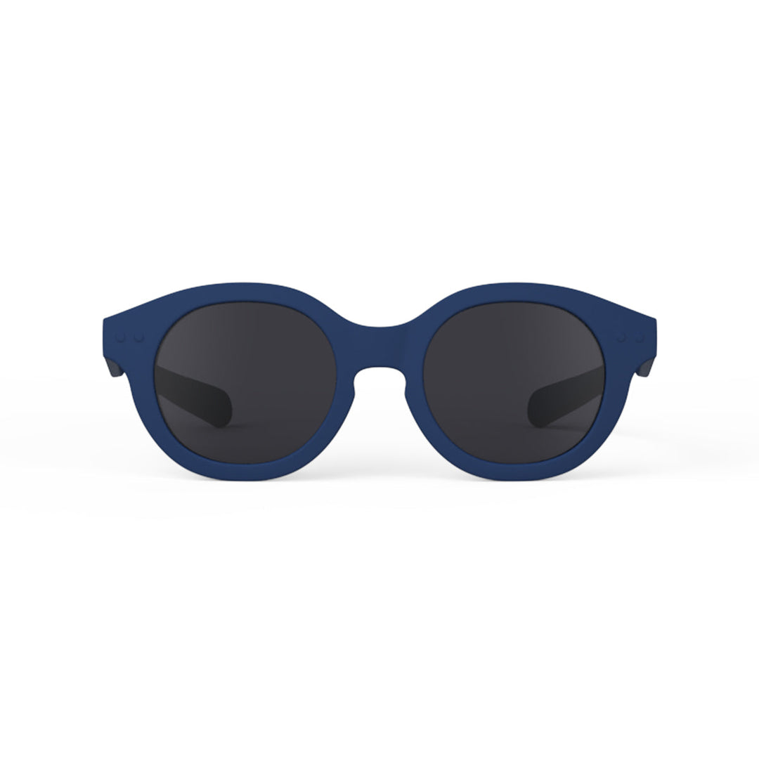Blue sunglasses with dark lenses on a white background
