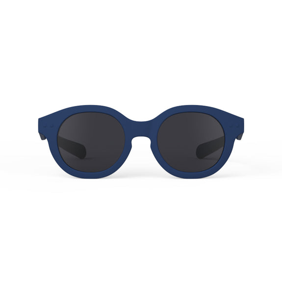 Blue sunglasses with dark lenses on a white background