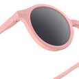 Pink sunglasses with dark lenses on a white background