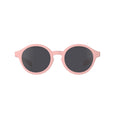 Pink sunglasses with dark lenses on a white background