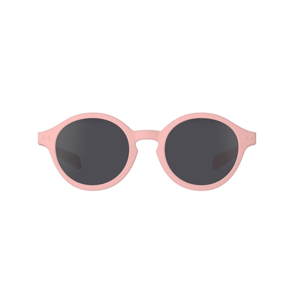 Pink sunglasses with dark lenses on a white background