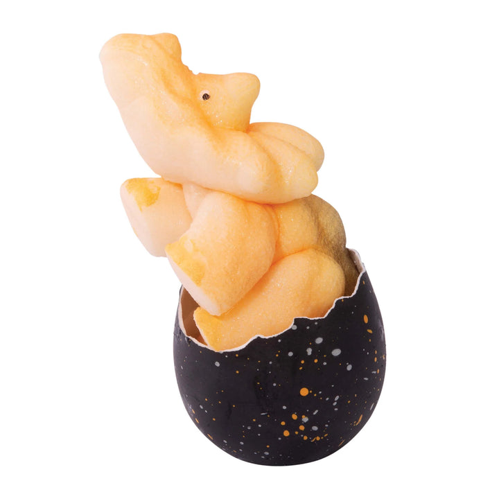 Ceramic rabbit figure inside a black speckled egg on a white background