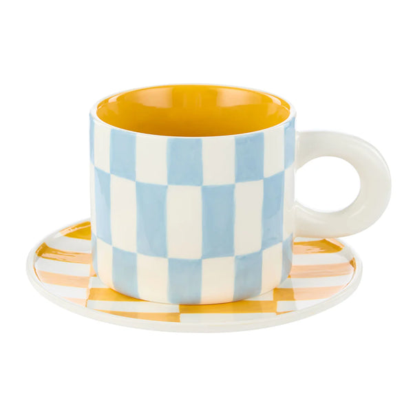 Colorful checkered mug and saucer on a white background