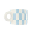 Checkered mug with blue and white pattern on a white background