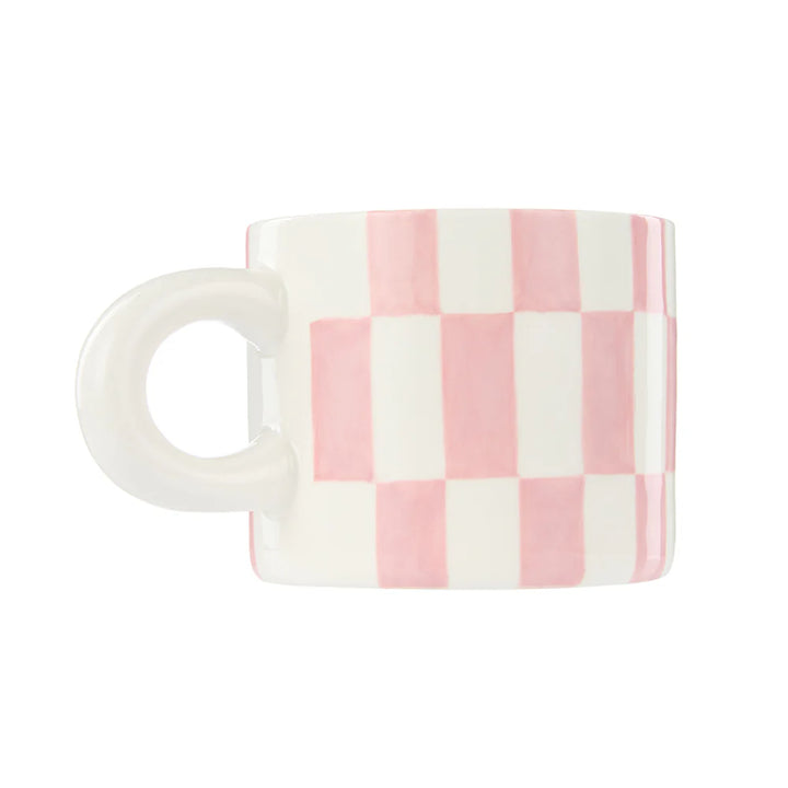 Checkered mug with pink and white pattern on a white background