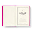 Open book with a pink cover and white pages displaying text.