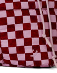 Checkered bag with pink and red pattern and white drawstring on a white background