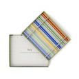 Set of colorful straws in a clear plastic case on a white background