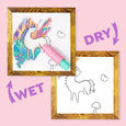 Unicorn-themed craft kit with a framed picture and wet/dry labels on a pink background