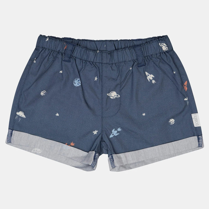 Blue shorts with space-themed print on a light gray background
