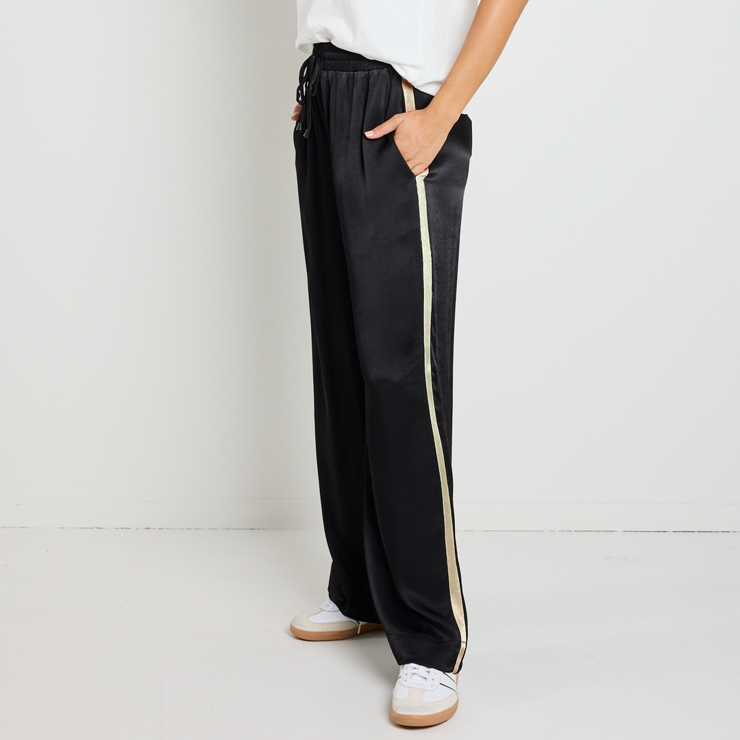 Upgrade your off-duty style with the Townie Black Satin Side Stripe Pants. Designed for ultimate comfort, available from www.thecollectivenz.com