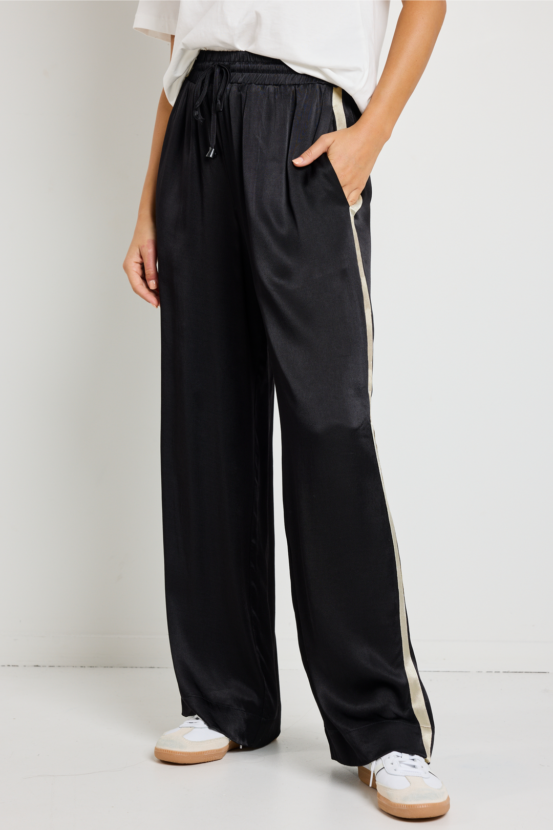 Upgrade your off-duty style with the Townie Black Satin Side Stripe Pants. Designed for ultimate comfort, available from www.thecollectivenz.com