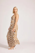 Woman wearing a eb & ive  brown and white striped dress on a light pink background