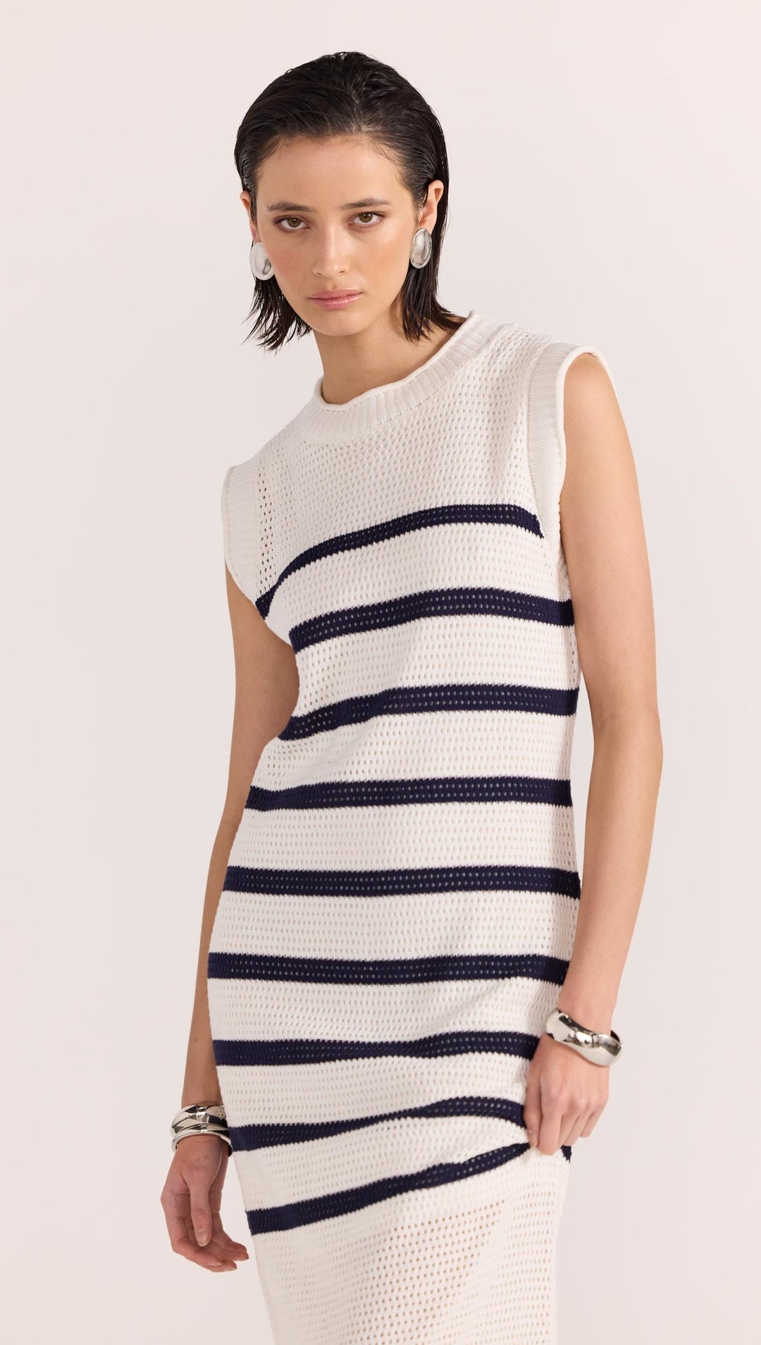 The Veda Stripe Midi Dress by Staple the Label features an open knit fabrication in 100% cotton, and a nautical white and navy striped pattern, available from www.thecollectivenz.com