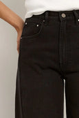 Black jeans worn by a person against a neutral background