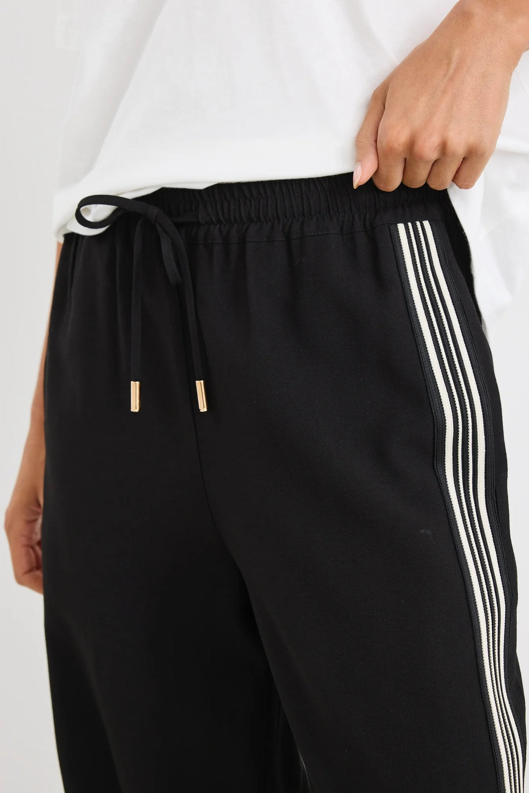 Black vibe pants with white stripes on a white background