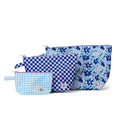 Set of three blue and white patterned pouches on a white background
