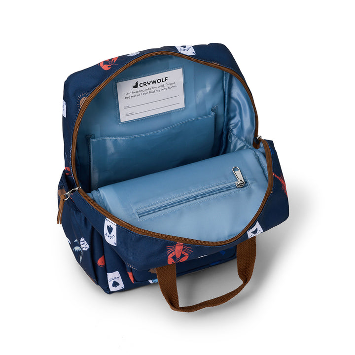Open blue backpack with visible interior and brand label on a white background