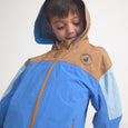 Child wearing a blue and brown jacket with a brand logo on a white background