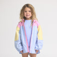 Child wearing a colorful jacket with pink, yellow, and light blue sections on a white background